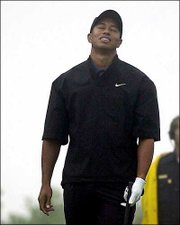 Anguish is displayed on Tiger Woods' face after his tee shot sailed
over the green on the par-3 third hole of the North Course at
Torrey Pines. Woods was 1 under when play was suspended Thursday
during the opening round of the Buick Invitational in San Diego.