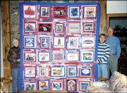 Jan Hartzler, in striped sweater, Shawnee, displays the Jayhawks
quilt she made for her parents, Bill and Carolie Hougland of
Lawrence. Bill Hougland played basketball for Kansas University,
and 10 members of the family have attended KU, including all five
of Bill and Carolie's children. The quilt, which is made of
T-shirts and digital pictures printed on cloth, was a Christmas
present. Carolie Hougland submitted the picture.