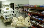 Sead Zulic, owner of the Golden Grain Bakery and Grocery, holds a
display of Bosnian and European breads sold in his store. Zulic
opened the first Bosnian business and bakery in the Bevo Mill
section of St. Louis, which during the past 10 years has seen a
large influx of Bosnians.