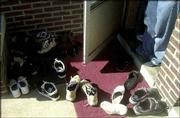 Shoes sit outside the house of a Bosnian family in St. Louis.
Bosnians usually remove their shoes before entering a house, a
custom originating with the Turks, who ruled Bosnia for 500 years.
A Saint Louis University sociologist who studies the Bosnian
community says that almost a decade after the first 13 Bosnian
families arrived in St. Louis, they now number nearly 50,000.