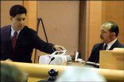 Deputy Dist. Atty. Gregory Dohi, left, plays for Los Angeles Police
Sgt. Charles Knolls a secret audiotape made by Bonny Lee Bakley
talking about her pregnancy. The tape was played Wednesday during
Robert Blake's preliminary hearing on the slaying of Bakley.