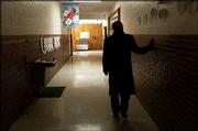 Supt. Randy Weseman walks along a Centennial School hallway in this photo from March 2003 on a tour of the building. Under the facility master plan, Centennial would be closed and its students moved to another school. Because of Centennial's proximity to Lawrence High School, Weseman envisioned the elementary school being used for special LHS activities.