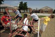 Enrollment in Lawrence's center-city neighborhood elementary
schools like Centennial, Schwegler and New York, shown here, has
been on a decline as it has increased in schools on the city's
fringe. Pictured at the New York School playground in this file
photo are, from left, Jonathan Luna, 10, Stephen Obiefule, 9,
Nathan Jalali, 8, Caleb Walker, 9, Nate Davis, 9, and Nolan
Whipple, 8.