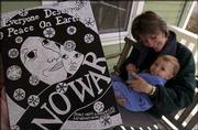 Lawrence artist Lora Jost created a piece of art advocating peace
and printed the image onto postcards. The art was inspired by a
moment shared with her 11-month-old son, Nicholai.
