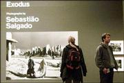 Visitors look at some of Brazilian photographer Sebastiao Salgado&squot;s
photographs in his exhibition at the Barbican Gallery in London.
"Exodus,"&squot; a collection of 350 black-and-white photographs,
explores the phenomenon of mass migration at the end of the 20th
century and is the first major showing of Salgado&squot;s work in Britain
in 10 years.