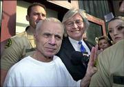 Escorted by sheriff's deputies, actor Robert Blake talks with
reporters after being released from jail in downtown Los Angeles.
Blake posted $1.5 million bail and was freed Friday to await trial
on charges of killing his wife.