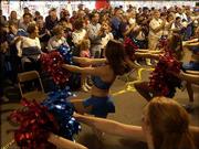 KU fans cheer as the Crimson girls and Pep band entertain during a
KU pep rally at VictoryFest in the West End in Dallas TX before
KU's tipoff against MU.