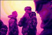 Under an orange sky, soldiers cover up from the blowing sand in the
desert near Karbala, Iraq. The troops, part of task force 4-64 in
the 3rd Infantry Division, have been stalled in the desert less
than 100 miles from Baghdad because of the inclement weather.