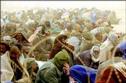 About 600 detainees huddle together Wednesday in central Iraq. The
prisoners are from heavy fighting by the 3rd Infantry Division in
Al Hillah and Al Samahwah during the previous two days.