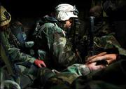 LCpl. Luis Delaluz from San Fernando, Calif., of the 15th U.S.
Marine Expeditionary Unit, takes a break in an AAV-P7A1 Assault
Amphibian Vehicle during an operation Thursday in the desert south
of An Nasiriyah, in central Iraq.