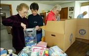 Elizabeth Pirtle, left, along with Cindy Herring, center, and
Marilyn Henry, right, pack hygiene products in boxes bound for
Afghanistan at Healing Hands International in Nashville, Tenn. The
group is preparing a shipment of aid to the war-torn country.