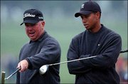 Tiger Woods, right, listens to Mark O'Meara on the 7th hole at the
Augusta National Golf Club. The two played a practice round Tuesday
to prepare for the 2003 Masters, which begins Thursday in Augusta,
Ga.