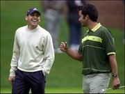 Sergio Garcia, left, yuks it up with amateur Alejandro Larrazabal
on the 16th hole at Augusta National Golf Club. The two practiced
Tuesday in Augusta, Ga., before Thursday's first round of the
Masters.