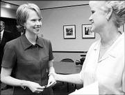 Lynn Parman, vice president of economic development for the
Lawrence Chamber of Commerce, left, chats with Mayor Sue Hack.
Parman says attracting Serologicals Corp. to Lawrence was the
highlight of her first year.