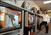 Robert Kendrick watches MSNBC broadcasting video of a Saddam
Hussein statue falling in Baghad, Iraq, in a television store in
Santa Clara, Calif. Cable news networks covered the war 24 hours a
day for three weeks and were rewarded with huge audiences. Now
they're looking for ways to hold on to those viewers as the war
winds down.