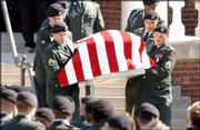 Fort Riley soldiers carry the casket of Sgt. Jake Butler, who was
killed April 1 in the war in Iraq. Funeral services were Monday at
Wellsville Baptist Church. Wellsville businesses closed in honor of
the services for the slain soldier.