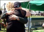 Jamie Pierce, a Fort Riley soldier who attended services for Sgt.
Jake Butler, is comforted by a friend at Wellsville Cemetery.
Monday&squot;s services included a bugler playing "Taps" and a 21-gun
salute.