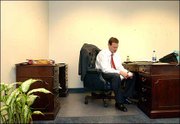 Greeted by an empty desk and blank walls, Bill Self opens a piece
of mail in his new office. Self, who was hired as Kansas
University's new men's basketball coach, moved Monday into Roy
Williams' old office.