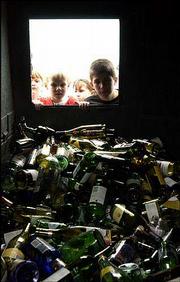 Vinland Elementary School students take a peek inside a glass
recycling bin at the Wal-Mart Community Recycling Center during a
tour of the facility. A field trip Wednesday to the center and to
the Baker Wetlands was part of the school's studies on the
importance of recycling and taking care of the environment. City
data show Lawrence recycles about 32 percent of the city's refuse,
one of the highest percentages in the state.