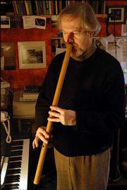 INGRAM MARSHALL PLAYS the gambuh, a Balinese flute, in his home
studio in Hamden, Conn. The 60-year-old composer has written enough
music to fill at least seven albums and produced numerous concerts.