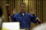 Kansas University director of bands John Lynch talks during
Monday's KU Wind Ensemble rehearsal. Lynch is finishing up his
first year as KU's director of bands and already has put his stamp
on the program.