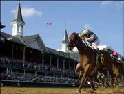 Funny Cide, with jockey Jose Santos, drives to win the Kentucky
Derby. Santos rode Funny Cide, a gelding, to the victory Saturday
at Churchill Downs in Louisville, Ky.