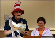Professor Dennis Dailey dons a Dr. Seuss hat and reads from "Oh,
The Places You&squot;ll Go,"on the last day of this semester&squot;s human
sexuality class. Dailey&squot;s graduate teaching assistant, Teresa
Scalise, listens in.
