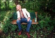 William S. Burroughs enjoys his back yard at his former Lawrence
home shortly before his death in August 1997.