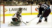 Anaheim's Petr Sykora (39) scores against Minnesota goalie Manny
Fernandez. The game-winning goal came during the second overtime
period of their Western Conference finals series opener Saturday in
St. Paul, Minn. The Mighty Ducks won, 1-0.