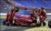 Bill Elliott's crew performs a pit stop during qualifying for The
Winston. Elliott won the pole for tonight's NASCAR all-star race
with an average speed of 131.502 mph for three laps, including the
pit stop, at Lowe's Motor Speedway in Concord, N.C.