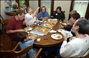 Members of Delaware Street Commons conduct a meeting over pizza.
They met Friday at the McMillan House, 1208 Del.