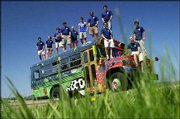 Middlebury College students with Project Bio Bus stand on the old
school bus modified to run on used vegetable oil in Middlebury, Vt.
The group is touring rock-climbing destinations and dropping off
college friends along the way while driving across the country this
summer.