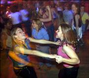 Courtney Vescig, left, and Katrina Morriss, both of Free State High
School, dance at the 2002 Project Graduation party. Seniors from
Free State, Lawrence High School and Bishop Seabury Academy will
attend their own Project Graduation beginning at 11 p.m. Sunday.