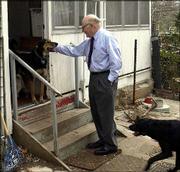 The Stevens household is home base to three dogs and three
"outdoor" cats. Dr. Phil Stevens is greeted by dogs Shy Guy, left,
and Sonny.