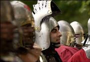 Michael Vennera, of Grandview, Mo., watches a battle with his
helmet open. Vennera and other members of the Society for Creative
Anachronism gathered Tuesday for some fighting in South Park.