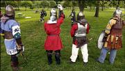 Members of the Society for Creative Anachronism wait their turn for
a battle as two members fight at South Park. The group gathered
Tuesday for a little hand-to-hand combat.