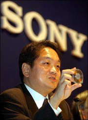 Ken Kutaragi, Sony's executive deputy president, holds a new MD
disk during a press conference in Tokyo. Sony Corp. on Wednesday
touted its revamped Playstation 2 videogame machine that also has a
DVD recorder and TV tuner, which will be able to download movies
and music using the disk.