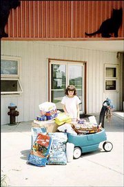 Elaney Pickering donates her birthday presents to the Lawrence
Humane Society. She turned 9 on May 15 and had a party May 17 for
her friends, whom she instructed to bring presents for donating to
the shelter. She is the daughter of Rebecca Pickering and John
Conrad, Eudora. Her grandparents are Bill and Judy Pickering,
Lawrence, and Jack and Mary Conrad, De Soto. Rebecca Pickering
submitted the photo.
