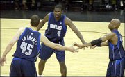 Dallas center Raef Lafrentz (45), guard Michael Finley (4) and
guard Nick Van Exel celebrate in the final minutes of their 103-91
win over San Antonio. The Mavericks beat the Spurs Tuesday in
Dallas.