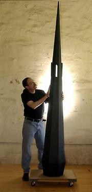 Jon Keith Swindell, a Kansas University professor and sculptor,
sands a wood sculpture in his Vinland studio. The sculpture,
"Sacred Spire/Beyond the Pale," is one of the pieces that will be
featured in Swindell's show at the Lawrence Arts Center from Friday
through July 18.