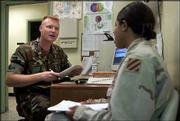 Physician's assistant Capt. Paul Jacobson conducts an interview
with Army Spc. Jennet Posey, of Chicago, as part of her post-Iraq
deployment health assessment at a family clinic on Fort Stewart,
Ga. The meeting is part of a series of checkups the Army requires
from soldiers returning from the war in Iraq.