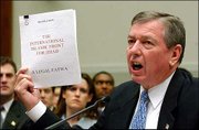 Atty. Gen. John Ashcroft holds a translated copy of a plan written
by the International Islamic Front for Jihad as he testified before
the House Judiciary Committee on Capitol Hill. Ashcroft asked for
expanded powers to hold suspected terrorists.