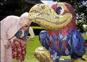 Rowena Pine, Lawrence, left, and her daughter Penny Hemphill,
Overland Park, get a close-up look at the mosaic patter on 'Chip
Off the Old Hawk,' at 15th Street and Kasold Drive. The women
toured the Jayhawks on Parade sculptures with other family members
after church and lunch Mother's Day, May 11.