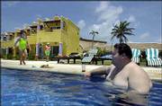 Angel Alonzo relaxes in the pool at the Freedom Paradise resort
south of Cancun, Mexico. The resort bills itself as the first "size
friendly" beach spot built to accommodate large people.