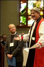 Retiring Bishop Douglas Theuner, right, introduces the Rev. V. Gene
Robinson to the Episcopal Church in Concord, N.H. New Hampshire
Episcopalians elected Robinson, an openly gay man, as their next
bishop.