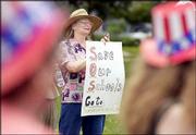 Vivian Caughey, Lawrence, holds a sign in support of funding for
public schools during a rally at South Park. Caughey, whose
contract was not renewed for the coming school year, was a nurse at
Broken Arrow elementary and South Junior High schools.