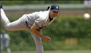 The Yankees' Roger Clemens delivers against the Cubs. Clemens
failed to earn his 300th career victory when the Cubs rallied for a
5-2 win Saturday in Chicago.
