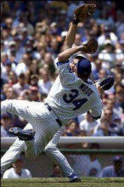 Cubs pitcher Kerry Wood (34) and first baseman Hee Seop Choi
collide. Choi was taken from the field in an ambulance during
Saturday's game at Wrigley Field. Choi suffered a concussion and
was listed in fair condition later Saturday.