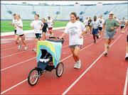 Isabella Hedges and her daughter, Kris, run during the last day of
Red Dog's Dog Days in this file photo. The summer conditioning
program, run by Don "Red Dog" Gardner, is dedicated to helping high
school athletes and adults stay in shape.