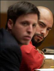 Damien Lewis, 22, right, listens to the family of victims in the
double murder of George "Pete" Wallace and Wyona Chandlee on July
11 2002. Lewis&squot; attorney Kirk Redmond is at his left.